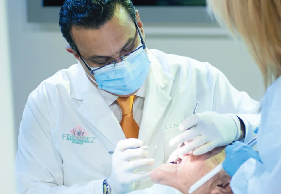 Dr. Fernandez treating a patient with his assistant